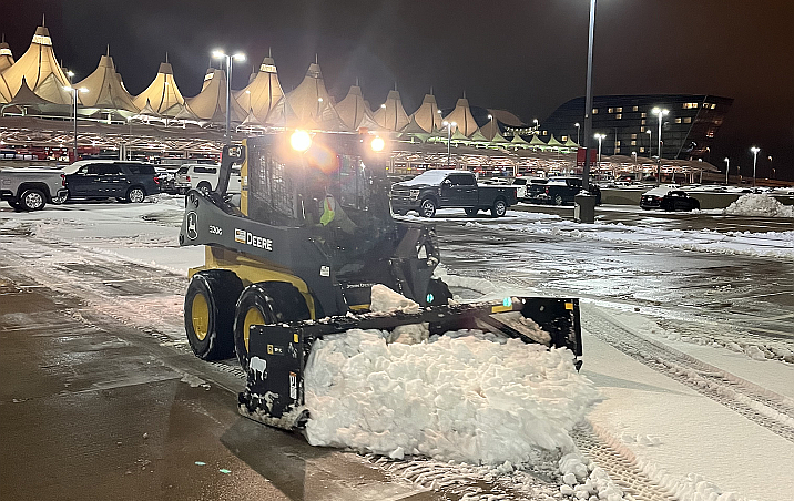 plowing snow at night at the airport